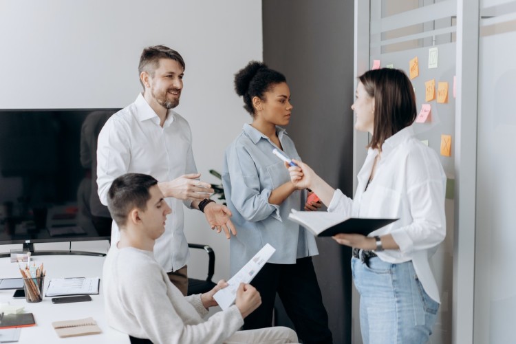 Studierende stehen an Whiteboard und überlegen